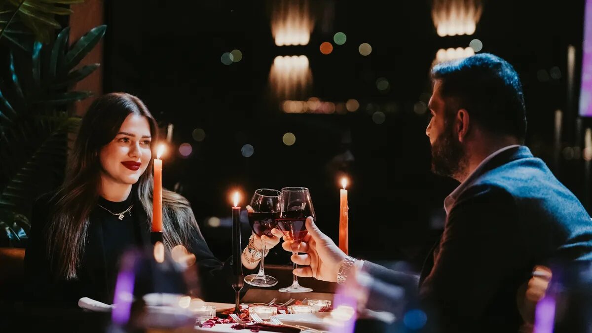 Couple toasting with wine at a candlelit table on the Bosphorus night cruise