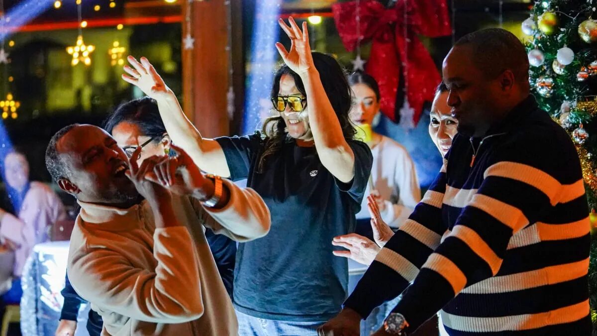 Guests dancing on the dance floor with the DJ during the evening cruise