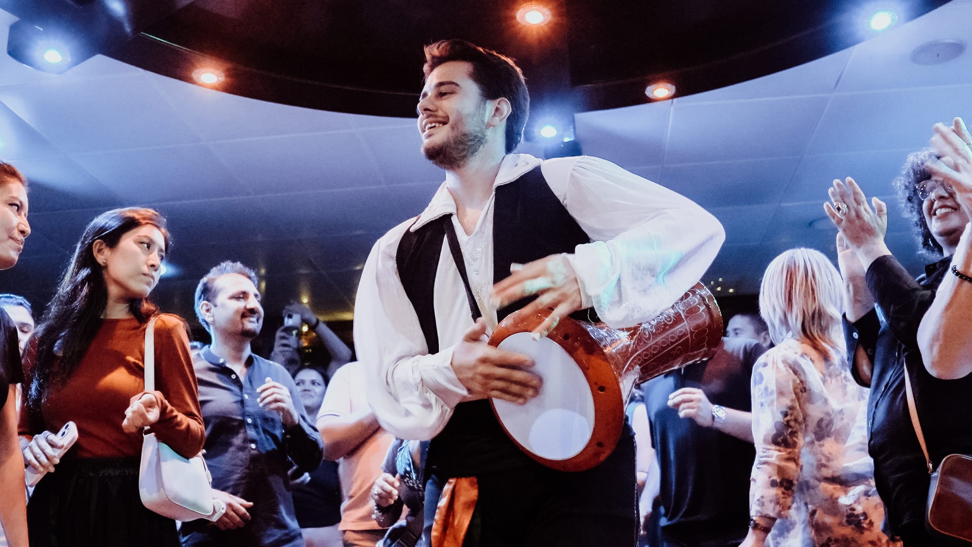 Live drummer performing among guests during the Turkish Night show