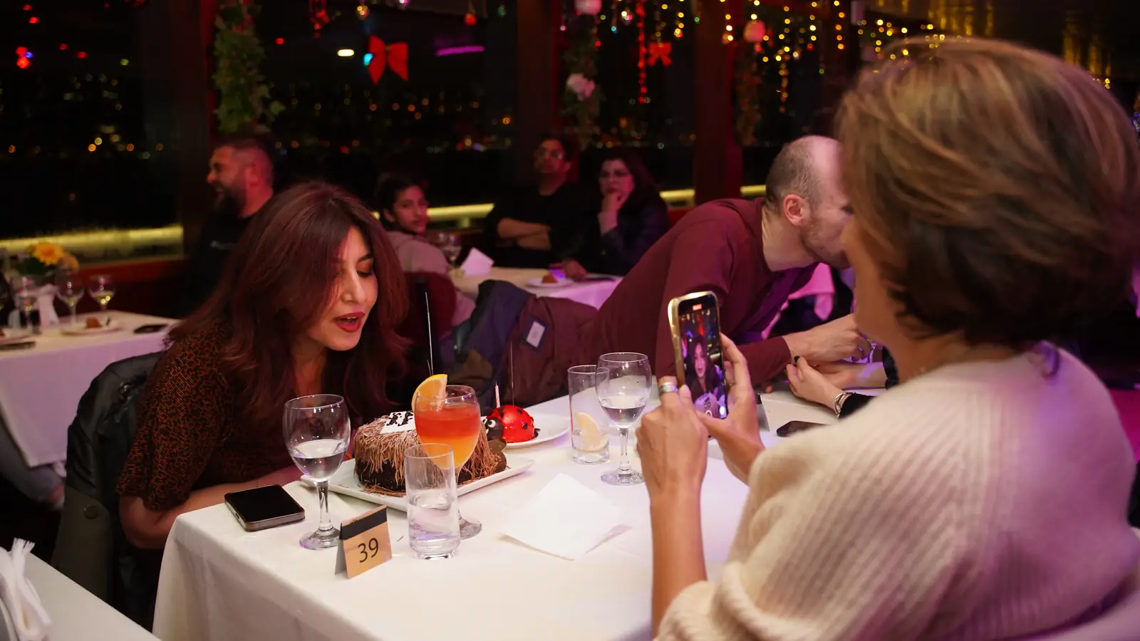 Guests celebrating at their table during the dinner cruise