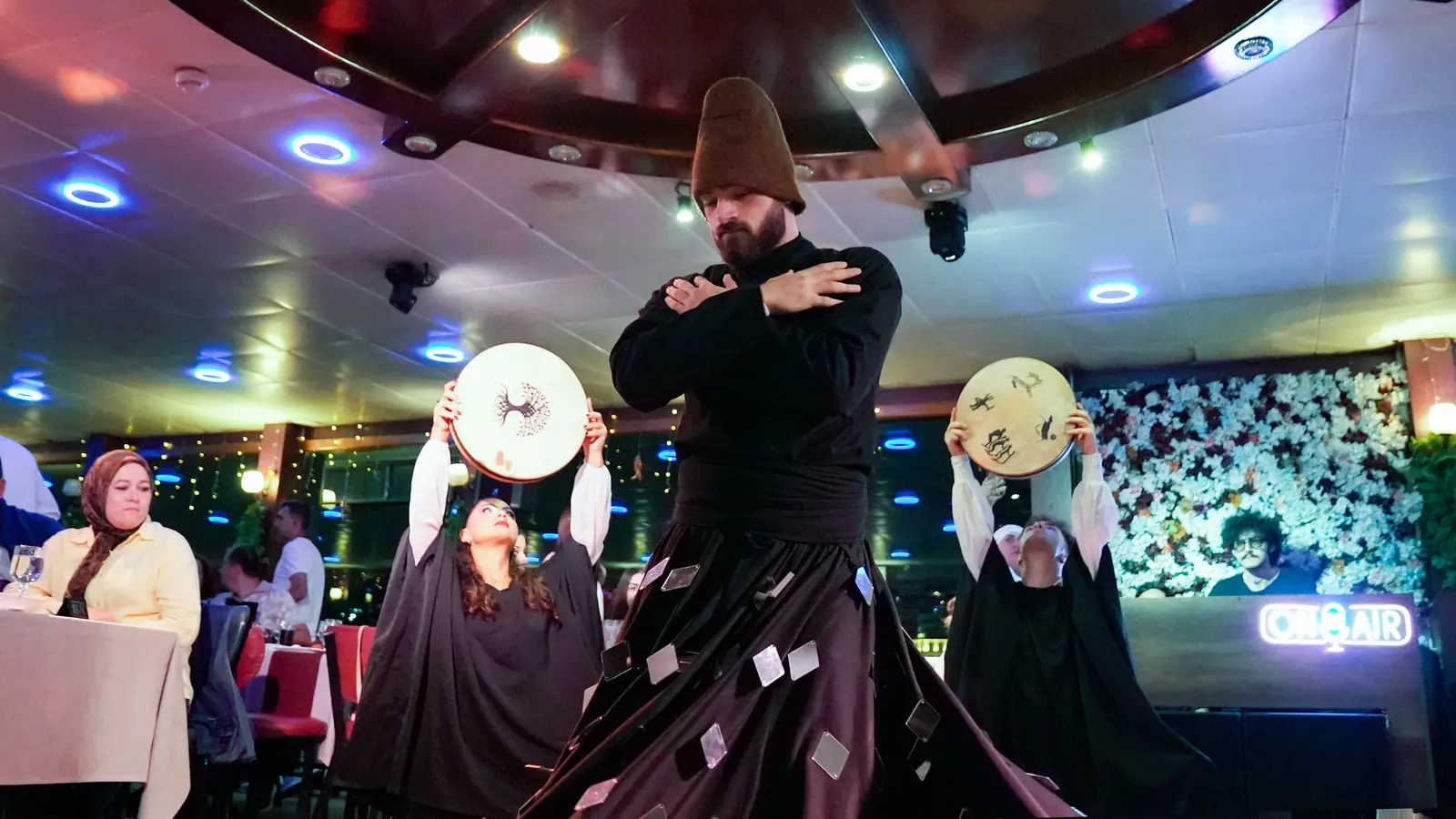 Whirling dervish and frame drum performers during the Turkish Night show